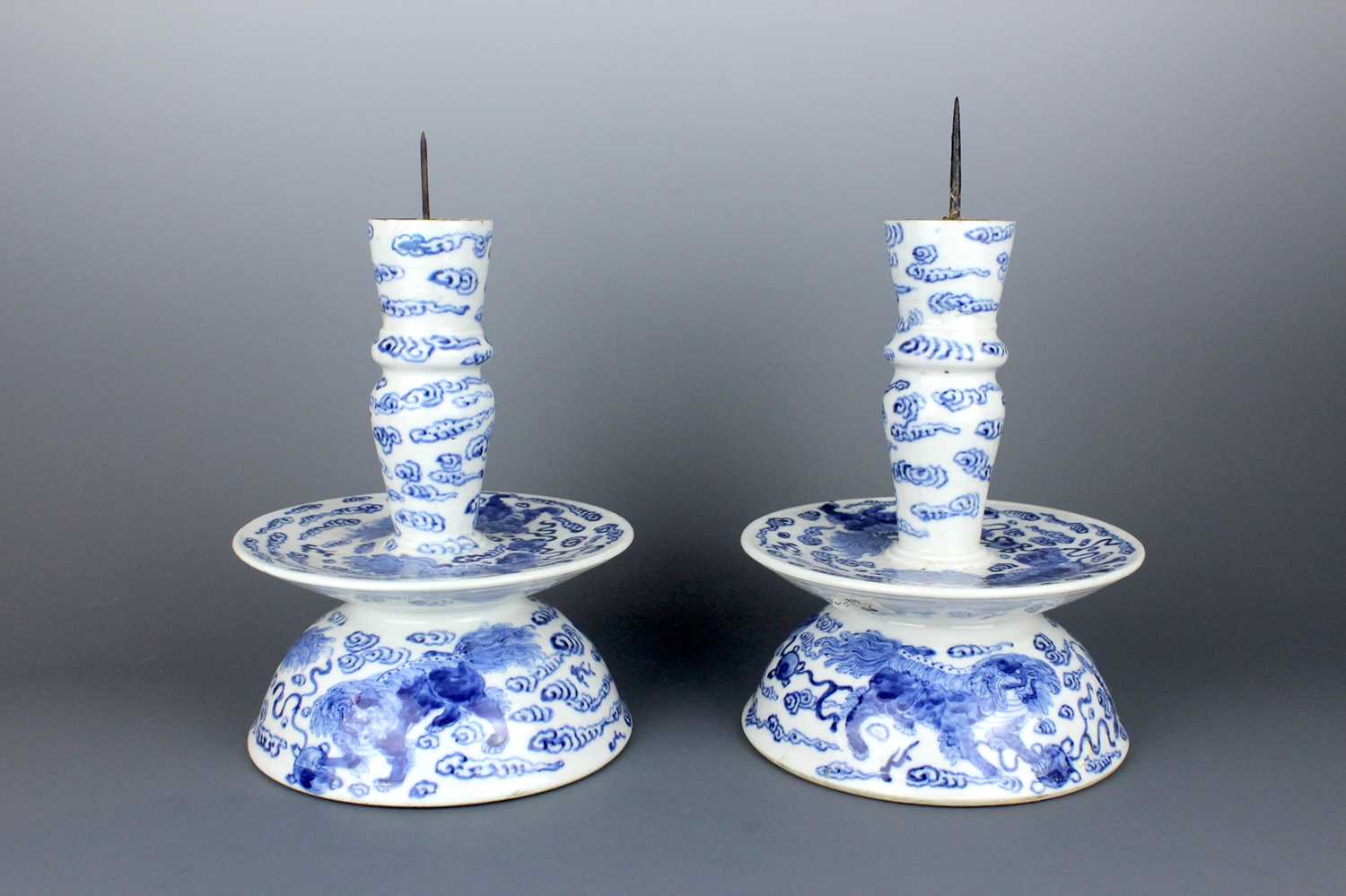 Lot 2023 - A pair of Chinese blue and white candle stands,...
