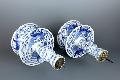 Lot 2023 - A pair of Chinese blue and white candle stands,...