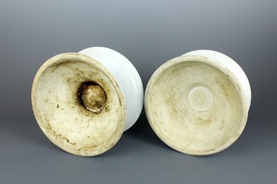 Lot 2023 - A pair of Chinese blue and white candle stands,...