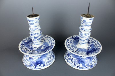 Lot 2023 - A pair of Chinese blue and white candle stands,...