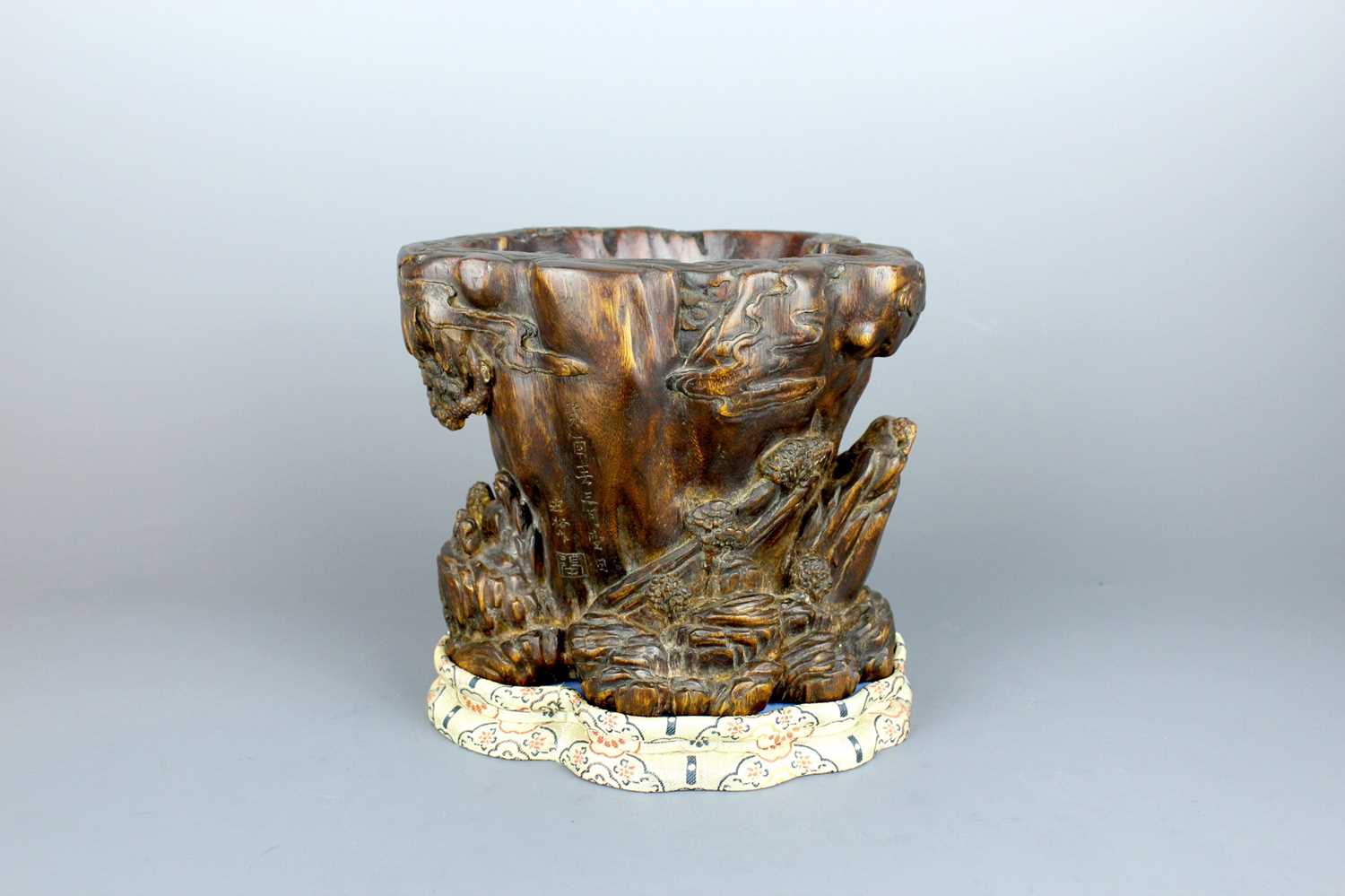 Lot 2087 - A Chinese wood-carved landscape brush pot,...