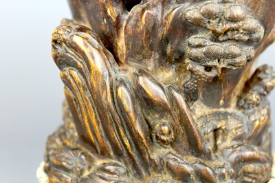 Lot 2087 - A Chinese wood-carved landscape brush pot,...