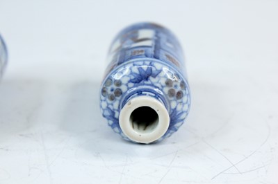 Lot 2001 - Three Chinese underglaze blue and red snuff...