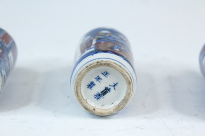 Lot 2001 - Three Chinese underglaze blue and red snuff...