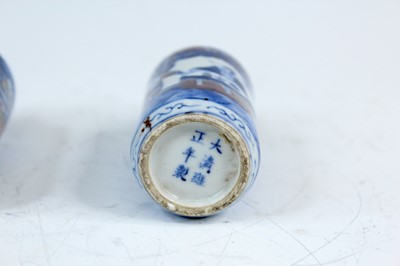 Lot 2001 - Three Chinese underglaze blue and red snuff...