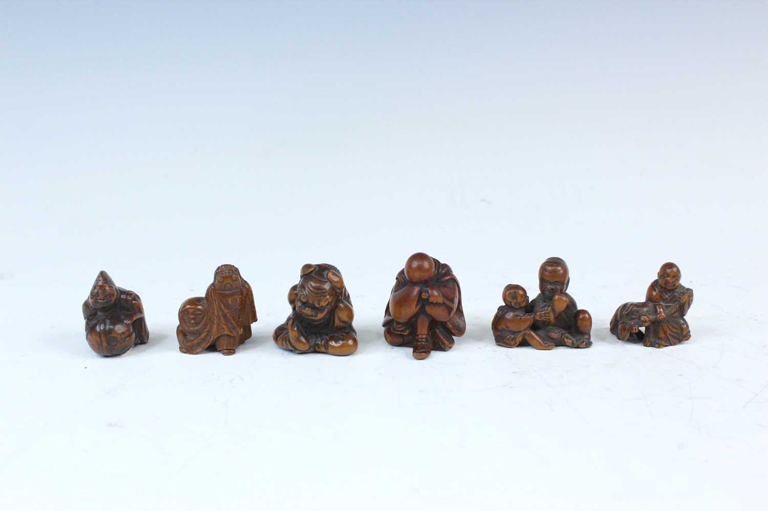 Lot 2233 - Six Japanese wood netsuke of seated figures,...