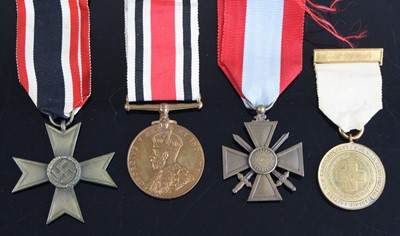 Lot 3310 - A group of four medals to include WW II German...