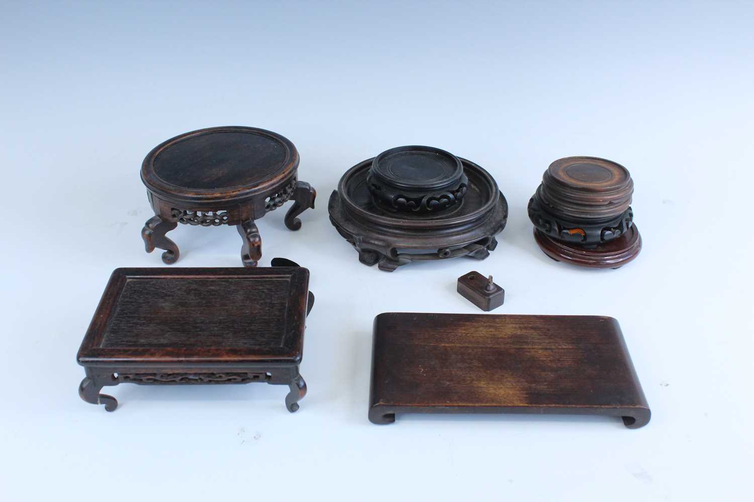 Lot 2094 - A group of Chinese wooden stands, comprising...