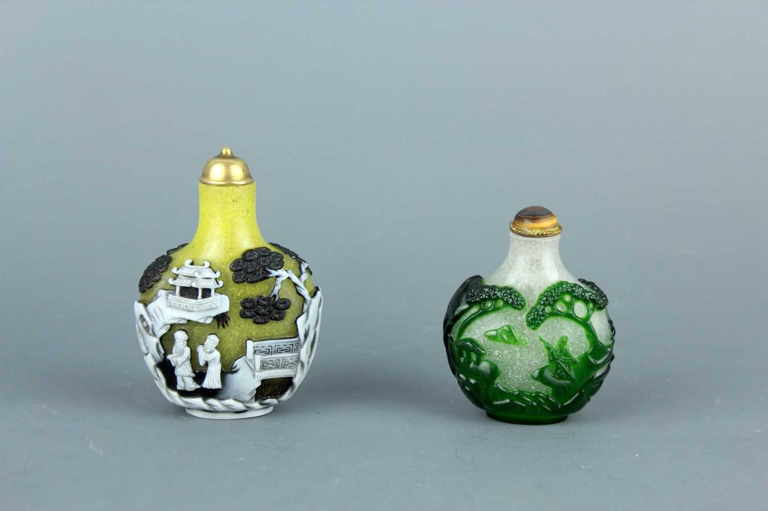 Lot 2012 - Two Chinese overlay glass snuff bottles, Qing...