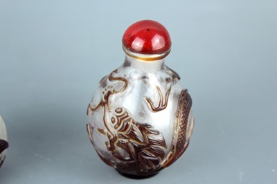 Lot 2013 - Two Chinese ‘dragon and phenix’ glass snuff...