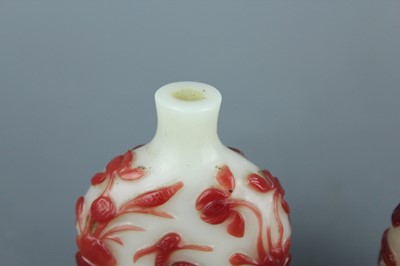 Lot 2019 - A set of three Chinese red overlay white glass...