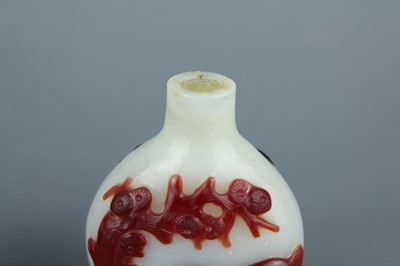 Lot 2019 - A set of three Chinese red overlay white glass...