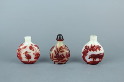 Lot 2019 - A set of three Chinese red overlay white glass...