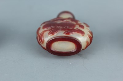 Lot 2019 - A set of three Chinese red overlay white glass...