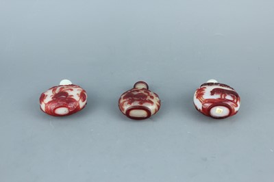 Lot 2019 - A set of three Chinese red overlay white glass...