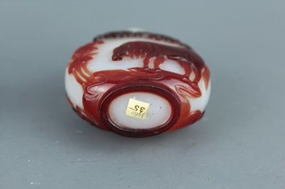 Lot 2019 - A set of three Chinese red overlay white glass...
