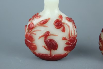 Lot 2019 - A set of three Chinese red overlay white glass...