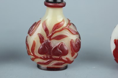 Lot 2019 - A set of three Chinese red overlay white glass...