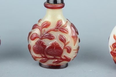 Lot 2019 - A set of three Chinese red overlay white glass...
