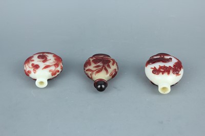 Lot 2019 - A set of three Chinese red overlay white glass...