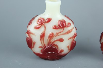 Lot 2019 - A set of three Chinese red overlay white glass...
