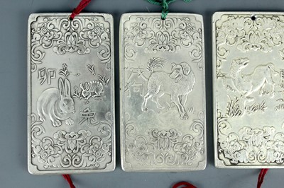 Lot 2058 - Seven Chinese white metal zodiac plaques...