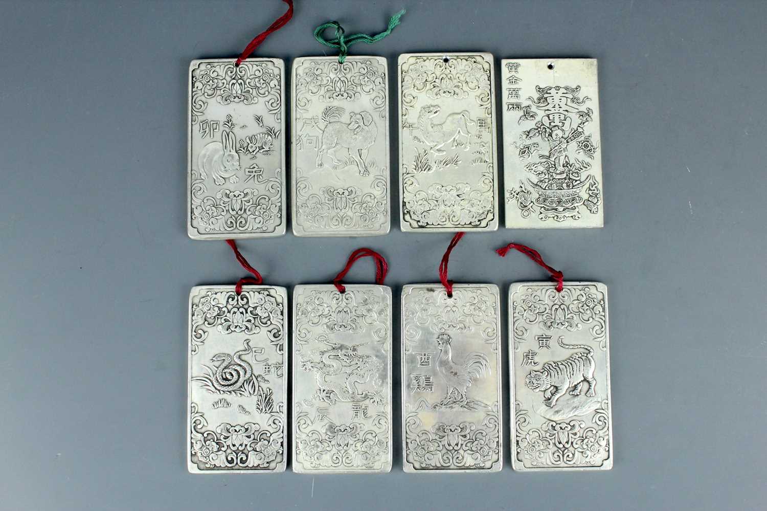 Lot 2058 - Seven Chinese white metal zodiac plaques...