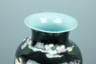 Lot 2080 - A Chinese black ground moulded ‘Eight...