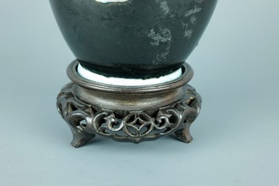 Lot 2080 - A Chinese black ground moulded ‘Eight...