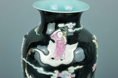 Lot 2080 - A Chinese black ground moulded ‘Eight...