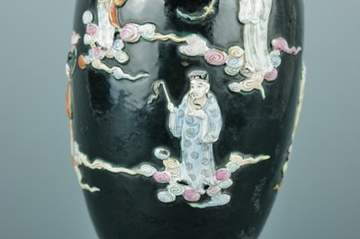 Lot 2080 - A Chinese black ground moulded ‘Eight...