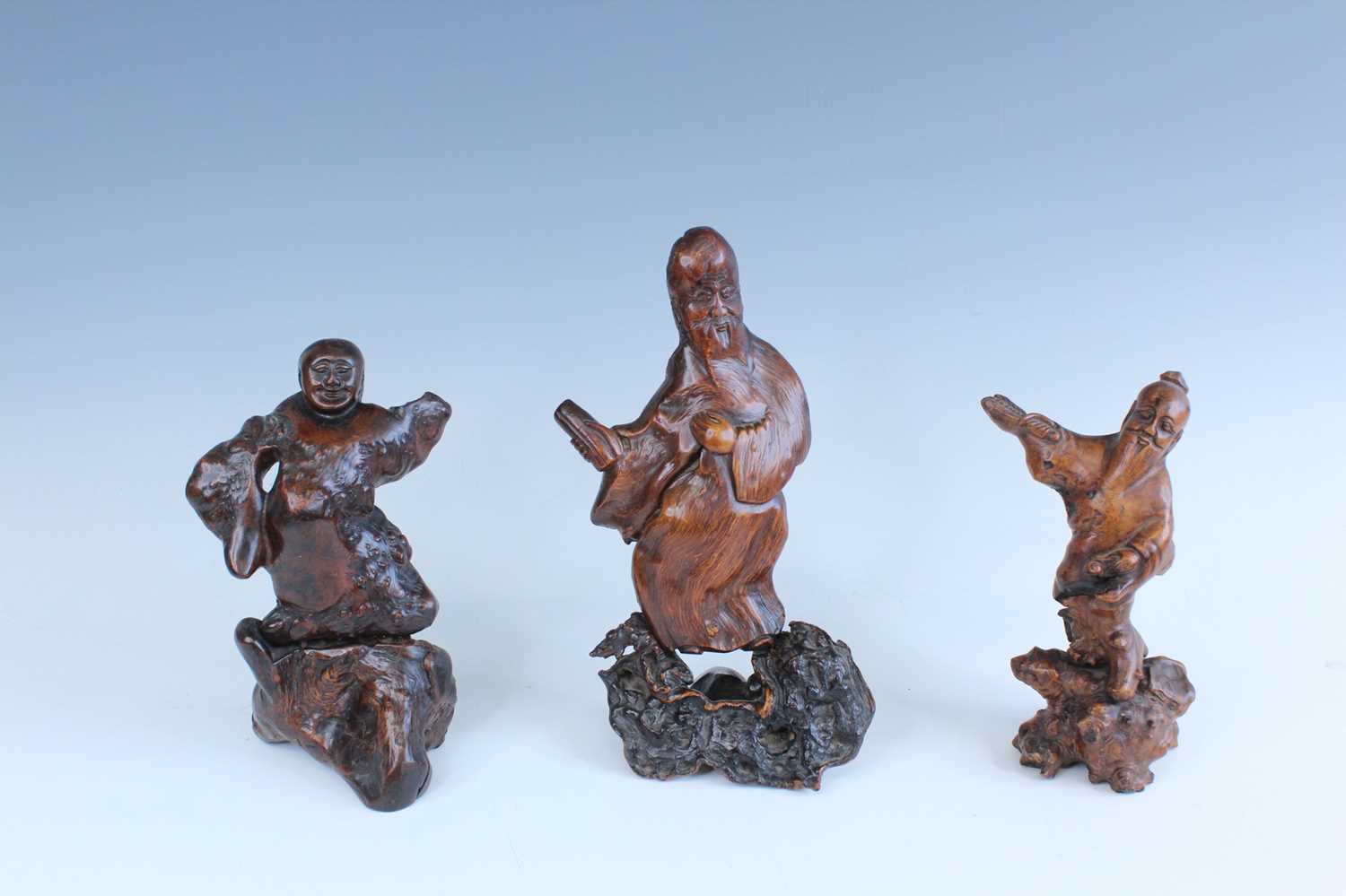Lot 2093 - A set of three Chinese wood carved immortal...