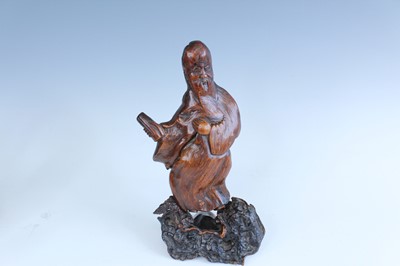 Lot 2093 - A set of three Chinese wood carved immortal...