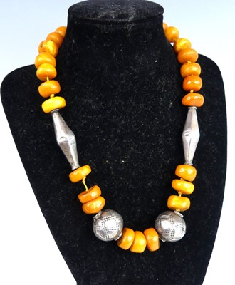 Lot 2644 - A rough butterscotch amber disc shaped...