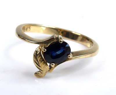 Lot 2653 - A yellow metal sapphire dress ring with an...