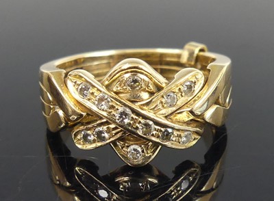 Lot 2661 - A yellow metal diamond puzzle ring featuring a...