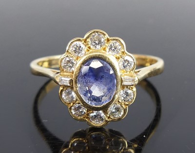 Lot 2674 - An 18ct yellow gold, sapphire and diamond oval...