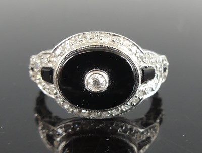 Lot 2681 - An Art Deco white metal, onyx and diamond...