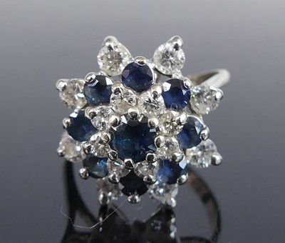 Lot 2709 - A white metal, sapphire and diamond circular...