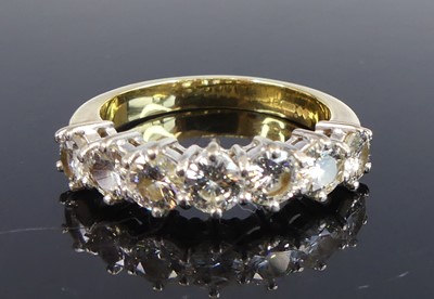 Lot 2710 - An 18ct yellow and white gold diamond half...