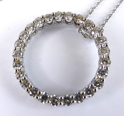 Lot 2717 - A white metal diamond circular pendant,...
