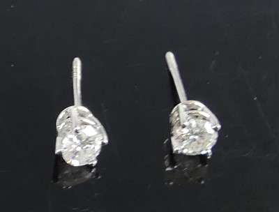 Lot 2726 - A pair of white metal diamond single stone...