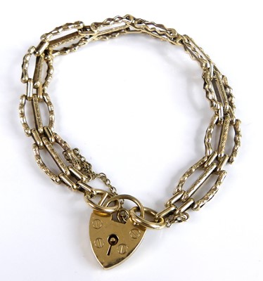 Lot 2735 - A 9ct gold gate link bracelet having heart...