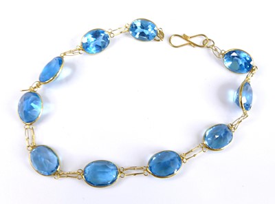 Lot 2695 - A contemporary yellow metal and blue topaz set...
