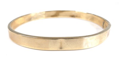 Lot 2699 - A 9ct hollow gold hinge bangle of square...