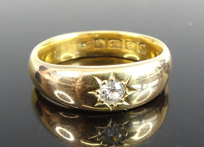 Lot 2754 - A 22ct gold band ring, gypsy set with an old...