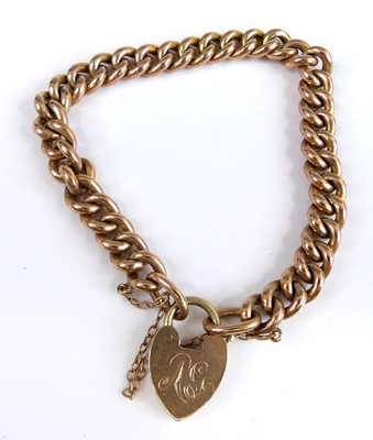 Lot 2758 - A 9ct gold curb link bracelet with heart...