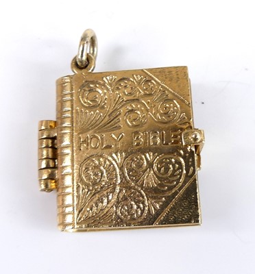 Lot 2760 - A 9ct gold charm of the Holy Bible, with...
