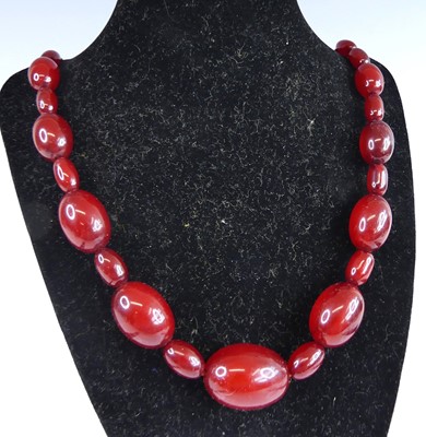 Lot 2792 - A cherry amber necklace arranged as barrel...