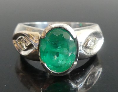 Lot 2807 - A white metal emerald and diamond dress ring,...